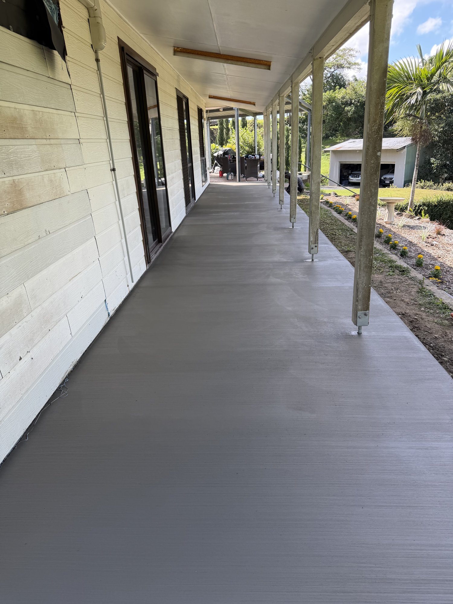Freshly poured concrete verandah slab on a Mackay home by Vertex Construction